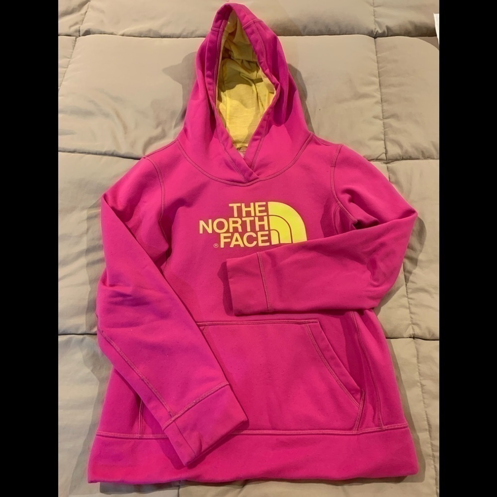 The North Face Womens hot pink hoodie with yellow lettering. Pullover. Size S/P.